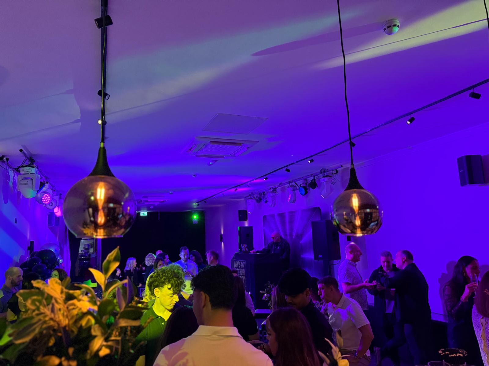 Guests gathered beneath the venue's distinctive lighting